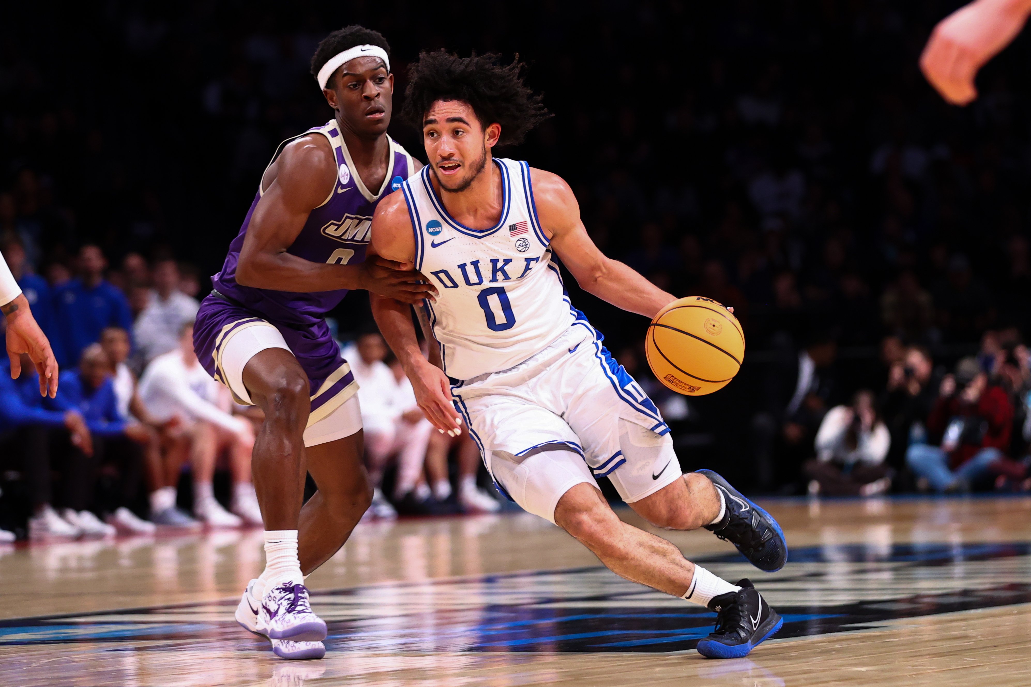 Jared McCain #0 of the Duke Blue Devils is defended by Xavier Brown #0 of the James Madison Dukes during the first half of the game during the second round of the NCAA Men’s Basketball Tournament at Barclays Center on March 24, 2024, in New York City.