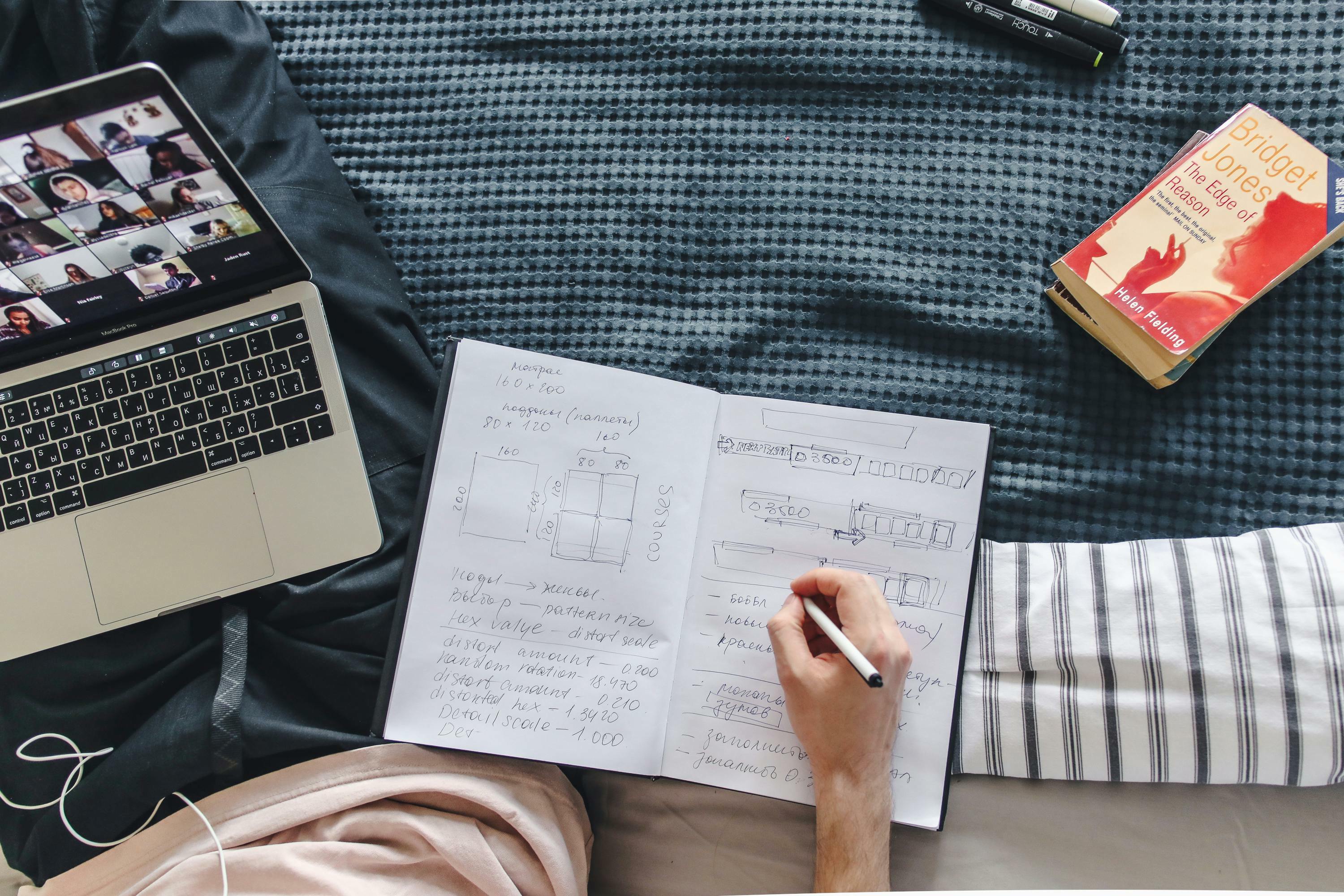 Notebook and laptop on bed