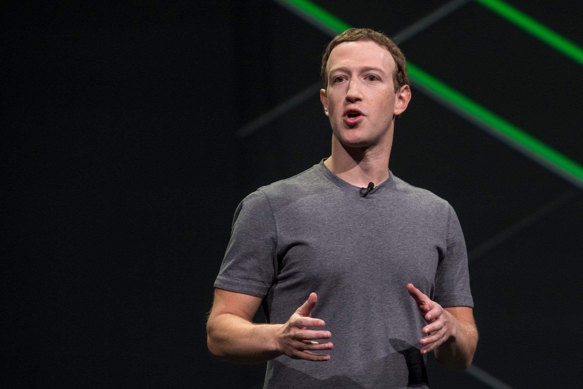 Mark Zuckerberg, mid sentence, dressed in a gray tee.