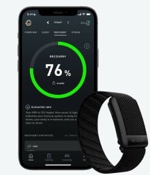 a black whoop wearable band with a cell phone displaying whoop metrics