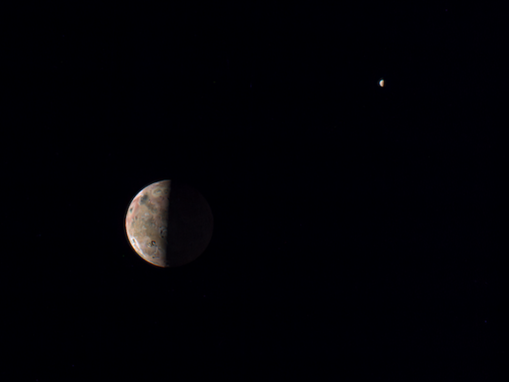 The Jovian moon Io, in the foreground, with the ice-clad moon Europa in the distance.