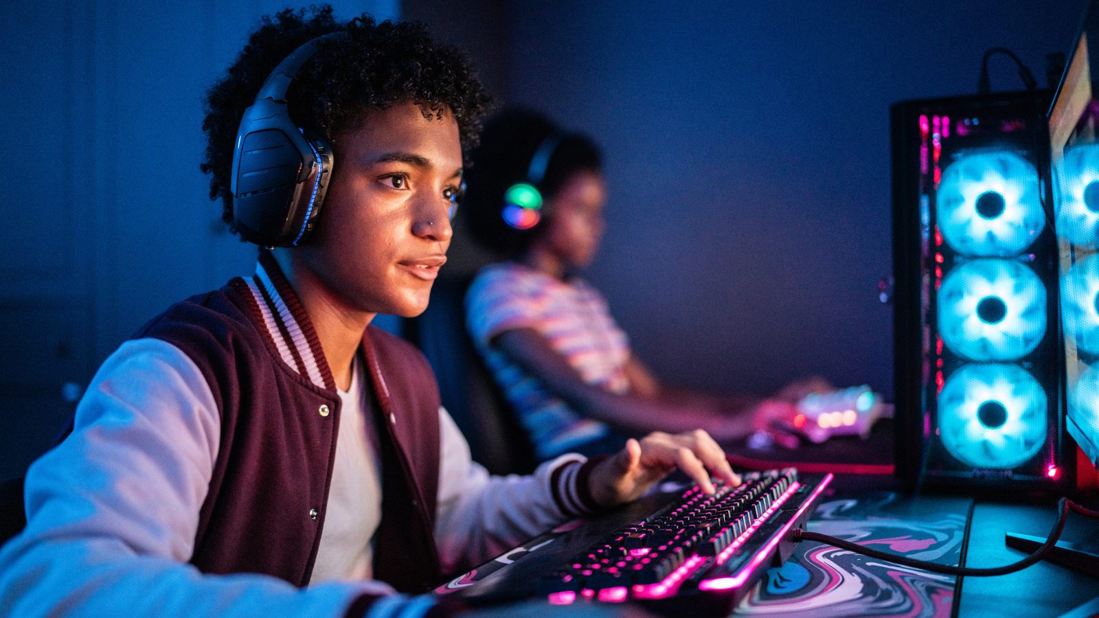 Teenage boy playing on the computer at home - stock photo