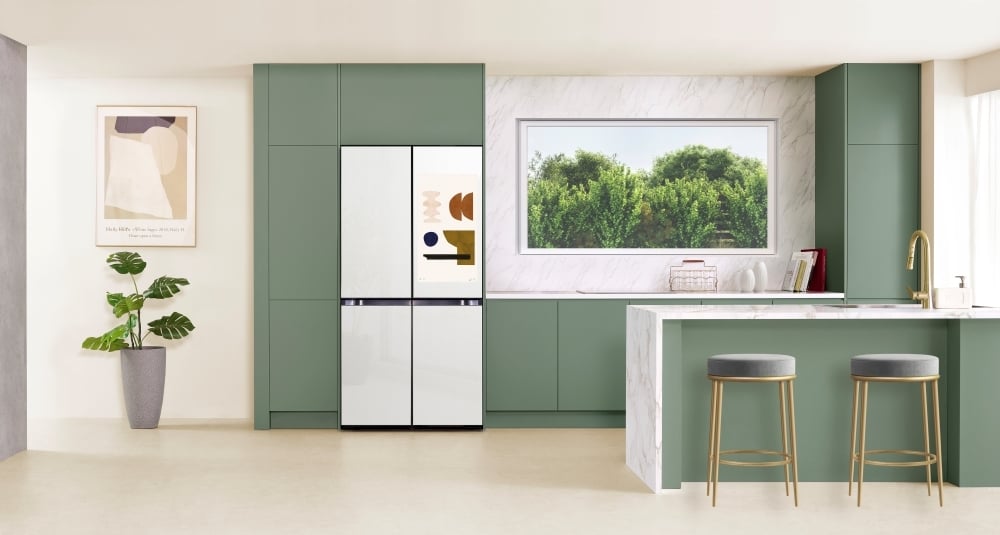 white samsung ai fridge pictured with cabinets in a full kitchen